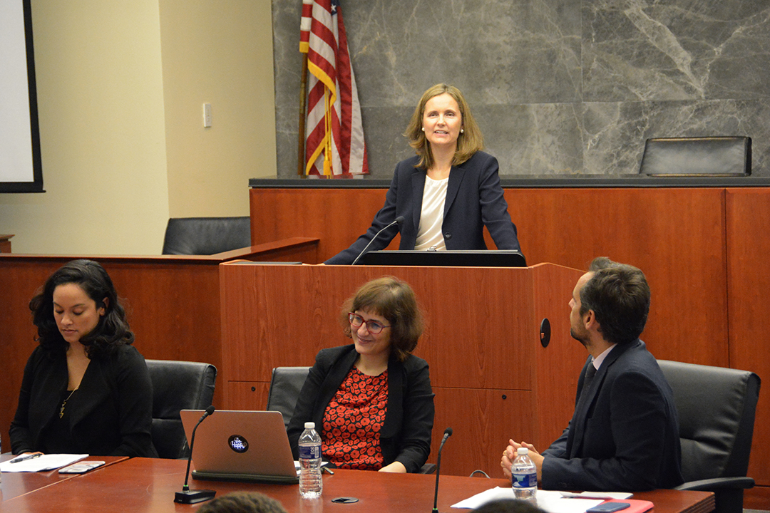 Francesca Bignami speaks behind a podium.