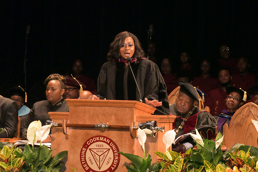 GW Law alumna Johanna Leblanc stands behind a podium and speaks to students at Bethune-Cookman University.