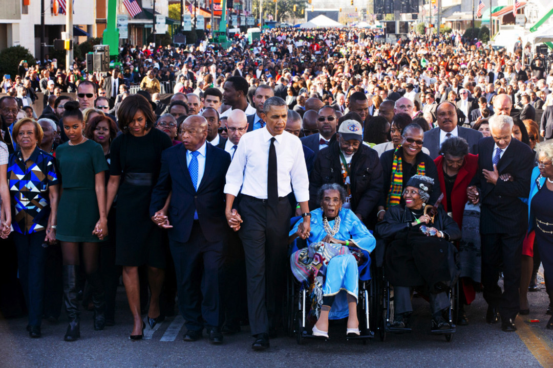 President Barack Obama marches with a crowd on the bridge in Selma, Alabama