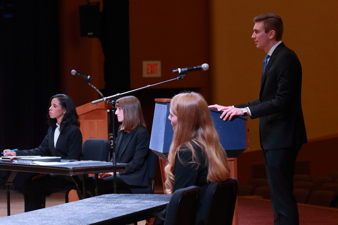 Shane Roberts, 2L, stands behind a podium presenting his argument at the 2020 Van Vleck Constitutional Law Moot Court Finals.