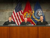 Navy-Marine Corps Court of Criminal Appeals Judges (Colonel) Alison Daly, (Captain) Nathaniel Gross, and (Lieutenant Colonel) Keaton Harrell sit in the judges bench in Burns Moot Court Room.