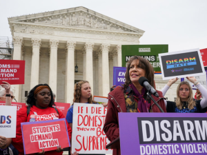 Ruth Glenn, president of Survivor Justice Action, addresses at a rally in front of the Supreme Court to call on the justices to disarm domestic violence perpetrators and protect survivors