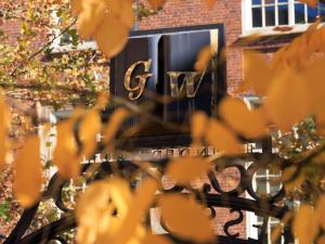 GW Professors Gate with fall leaves in the foreground