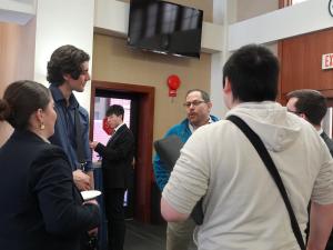 A group of students talk to a professor at the Adjunct Professor networking event.
