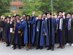 GW Law Dean Dayna Bowen Matthew, Harold Hongju Koh, and Associate Dean Steve Schooner pose with the class of 2025.