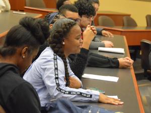 High school students listen to a panel lecture at GW Law.