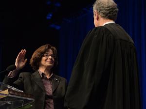 Professor Mary M. Cheh, left, poses with the Honorable Craig S. Iscoe, right, during the swearing-in ceremony.