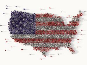 A photo of people in red, white, and blue standing together to form a large image of the United States of America.