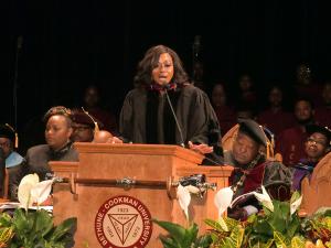GW Law alumna Johanna Leblanc stands behind a podium and speaks to students at Bethune-Cookman University.