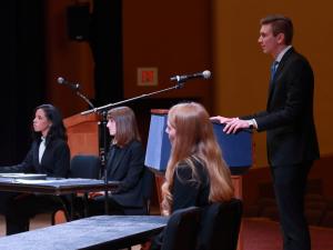 Shane Roberts, 2L, stands behind a podium presenting his argument at the 2020 Van Vleck Constitutional Law Moot Court Finals.