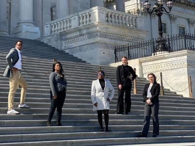 GW Law students stand on the steps at the U.S. Capitol.