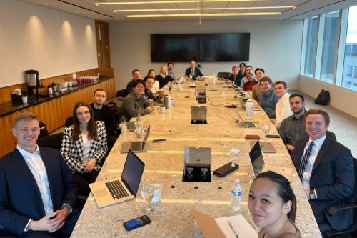 A group of GWNY students sitting at a conference table with Professor Kohn.