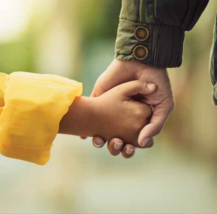 Parent holding a child's hand