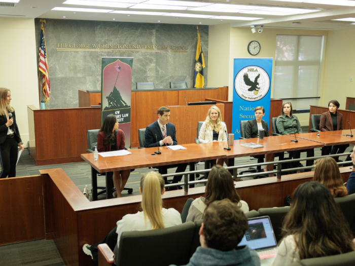 The alumni panel talking to the crowd in the moot courtroom