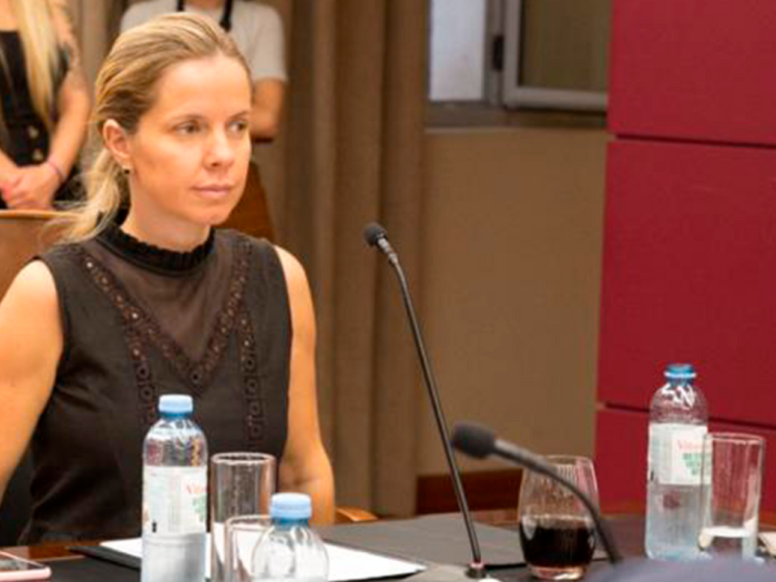 Genoveva Ferrero sitting at a table with a mic