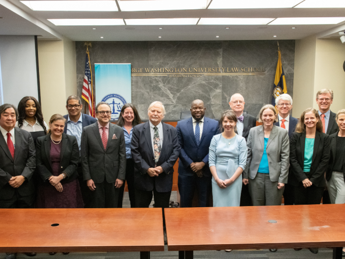 The GW Law group with their symposium panelists posing for a picture