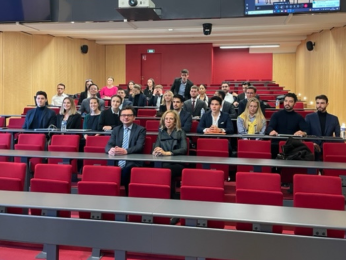 Professor Karen B. Brown sitting in front of students in an auditorium