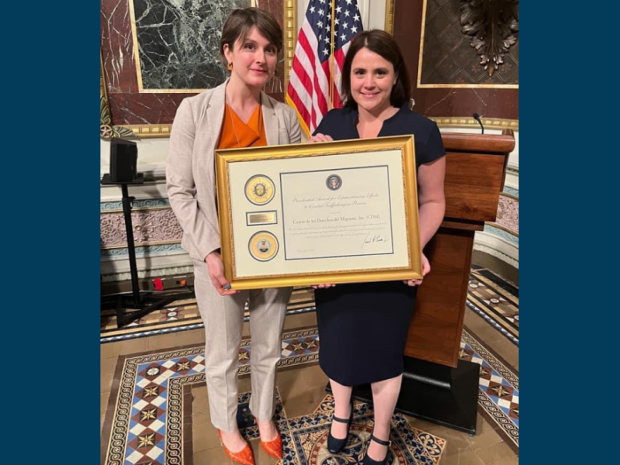 Cori Alonso-Yoder and Rachel Micah-Jones holding the Presidential Award for Extraordinary Efforts to Combat Trafficking in Persons