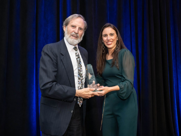 Dean Alan Morrison receiving his lifetime achievement award from a woman