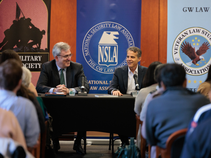 Professor Dan Richard and Eric O'Neill talking in front of a room of listeners