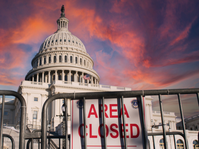 Capitol building with a fence and "area closed" sign
