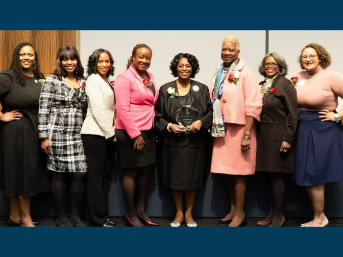 Dean Alfreda in the middle of a group of women holding her Charlotte E. Ray Award