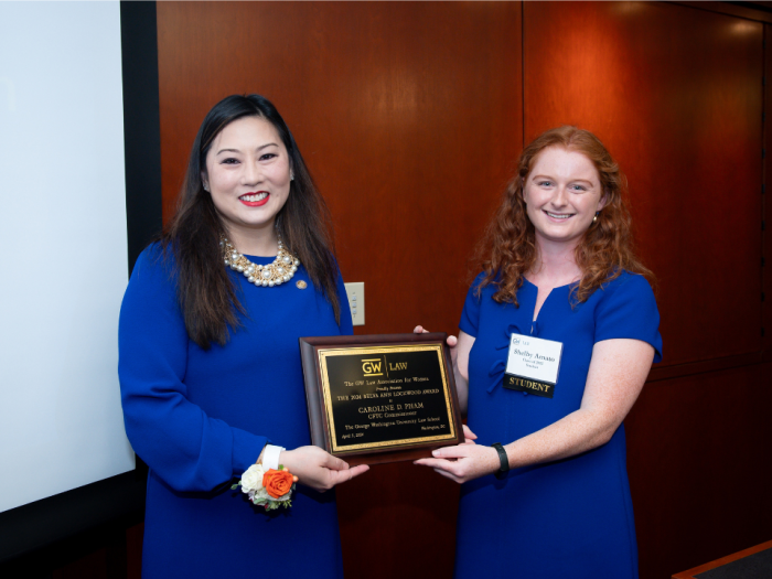 Caroline Pham and Shelby Amato holding the Belva Ann Lockwood plaque