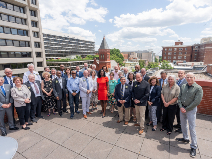 Multiple people standing for a picture on GW Law's rooftop