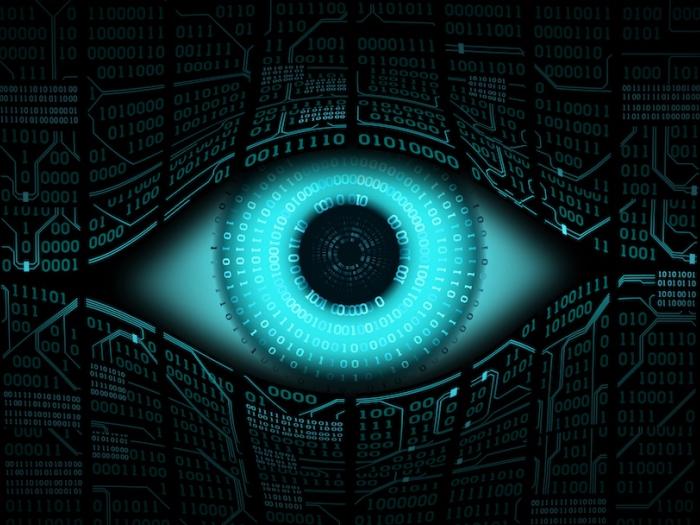 A digital image of an eye ball with computer text and coding surrounding it.