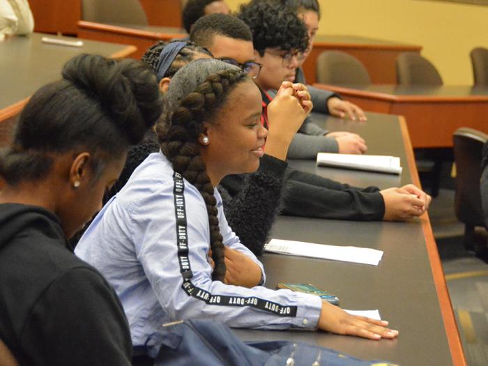 High school students listen to a panel lecture at GW Law.