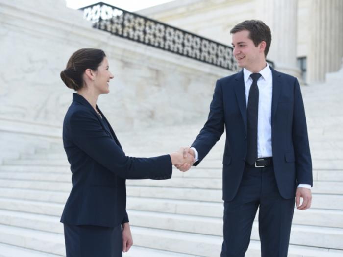 GW Law grads Whitney Hermandorfer (l) and David Fox on the steps of the Supreme Court, where they both have clerked for justices