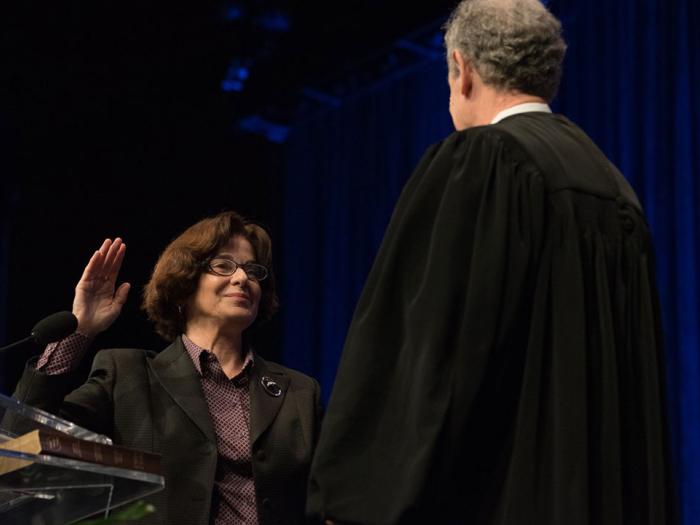 Professor Mary M. Cheh, left, poses with the Honorable Craig S. Iscoe, right, during the swearing-in ceremony.