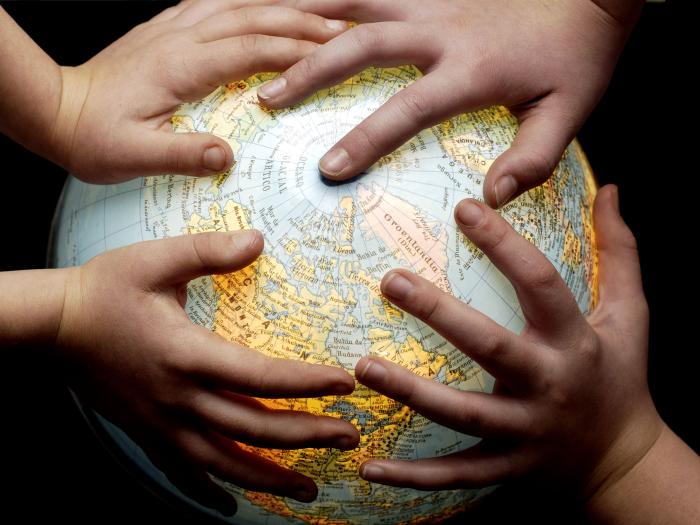 Photo of hands on a globe