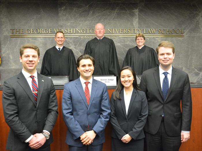 People stand together in the Moot Court Room