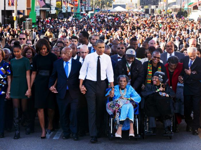 President Barack Obama marches with a crowd on the bridge in Selma, Alabama