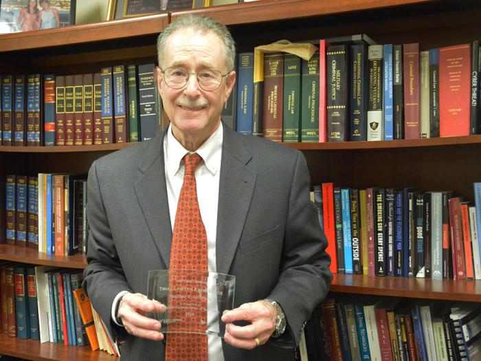 Professor Stephen A. Saltzburg poses with his Trial Lawyer Excellence Award. 