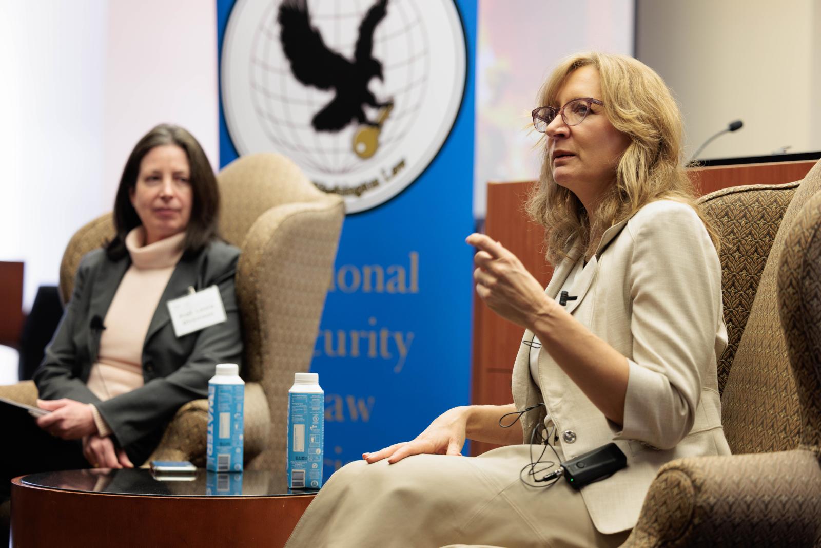 Professor Laura Dickinson listening to Ambassador Van Schaack talk