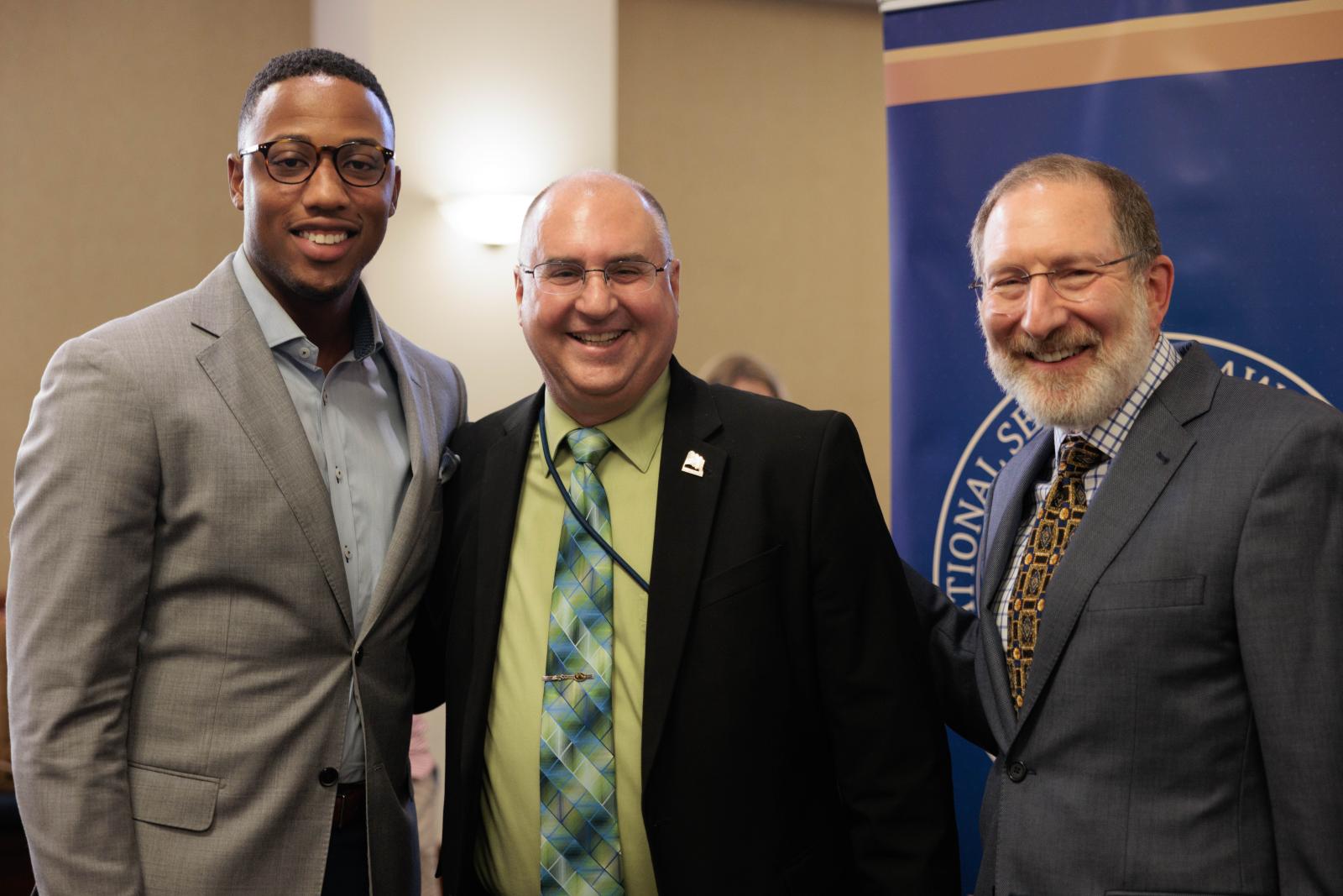 SBA President Shallum Atkinson, Retired Colonel Arnold, and Dean Schooner smiling