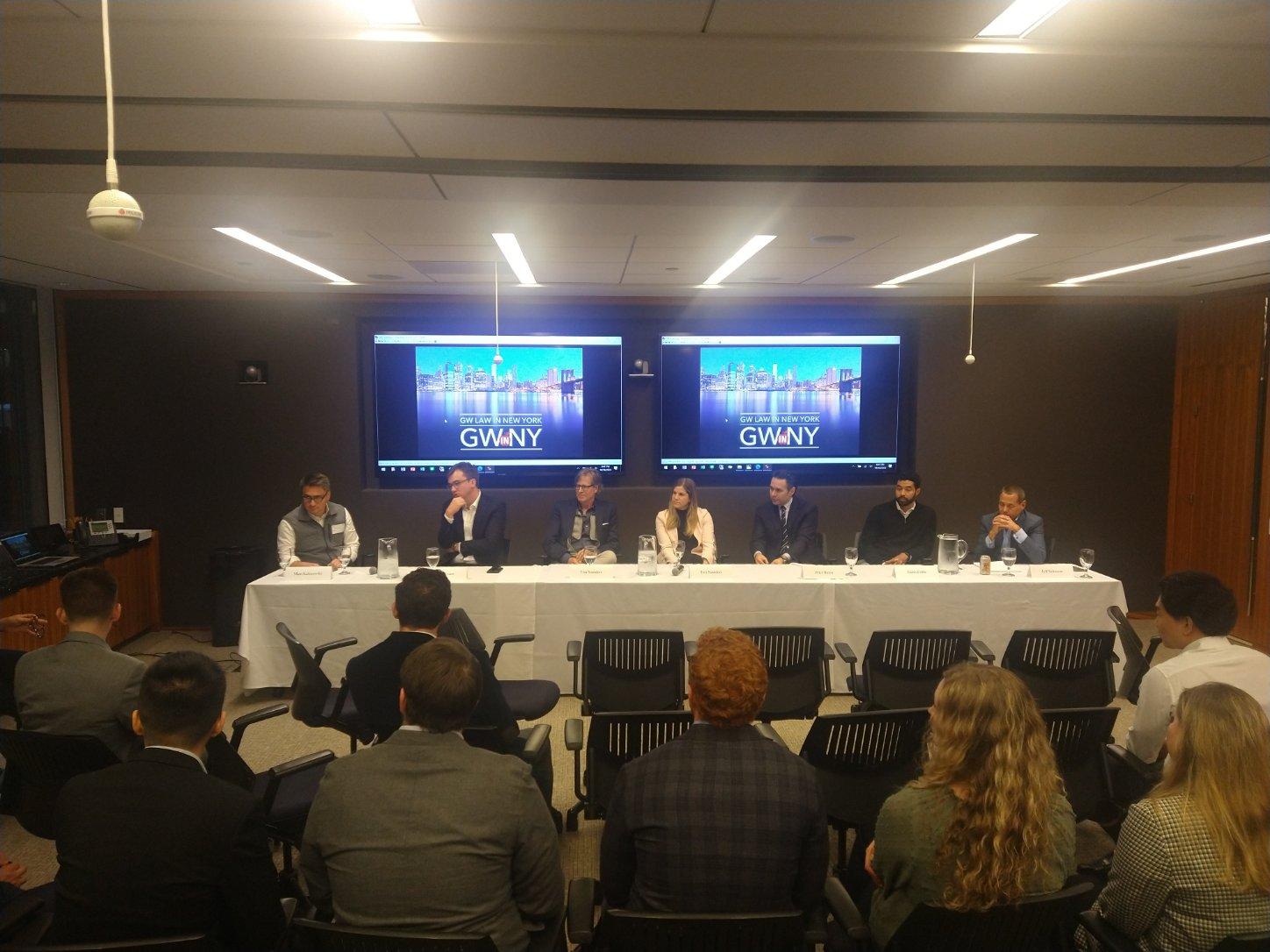A panel of speakers talking to GWNY students sitting in chairs
