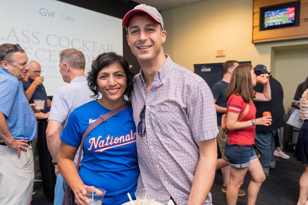A man and a woman posing for a photo at Nationals Park