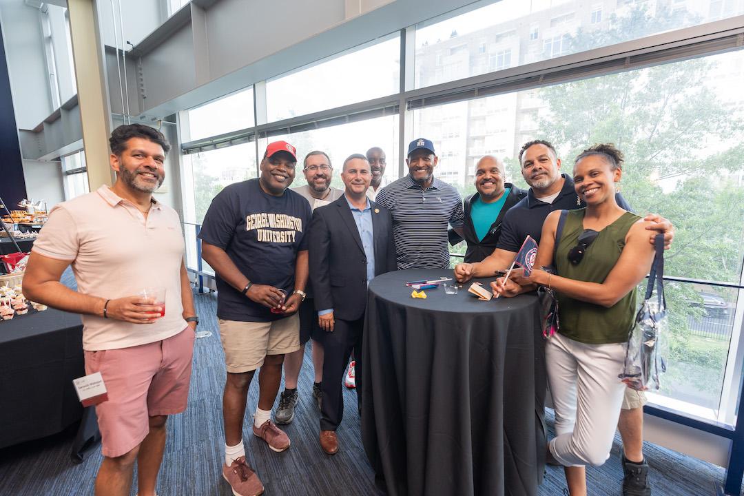 A group of alumni posing for a photo at Nationals Park