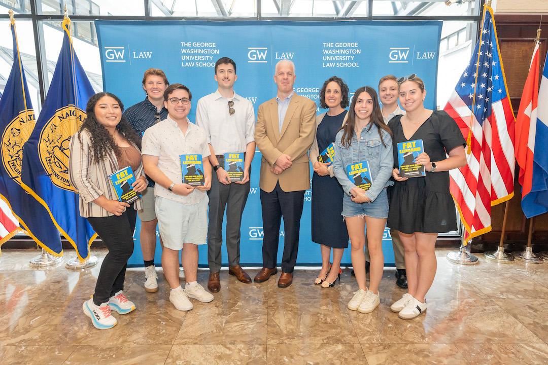 Alumni posing for a photo with Craig Whitlock