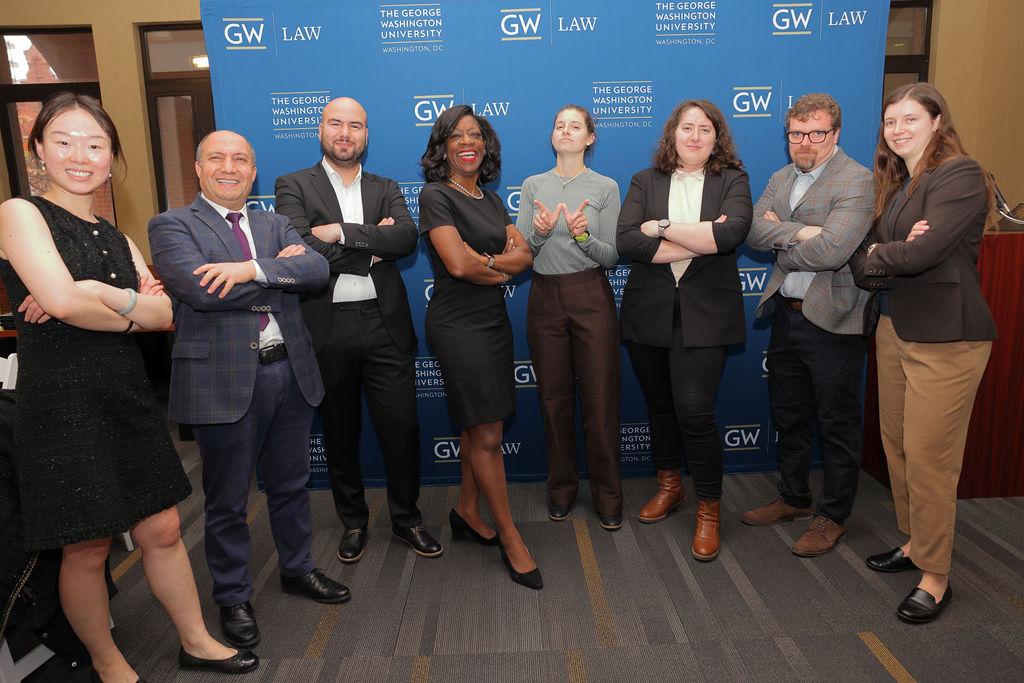 GW Law Dean Dayna Bowen Matthew poses for a photo with 2024 mid year graduates at the annual graduation luncehon