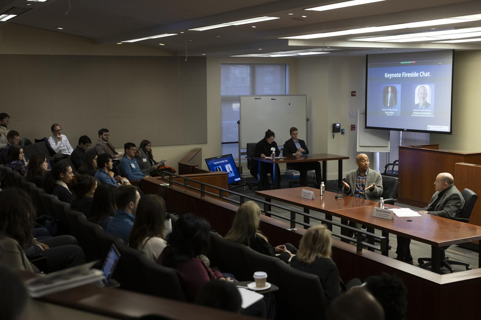 An audience of students listen to professors speak during the 2025 GW JOLT Symposium in the Burns Moot Court Room.