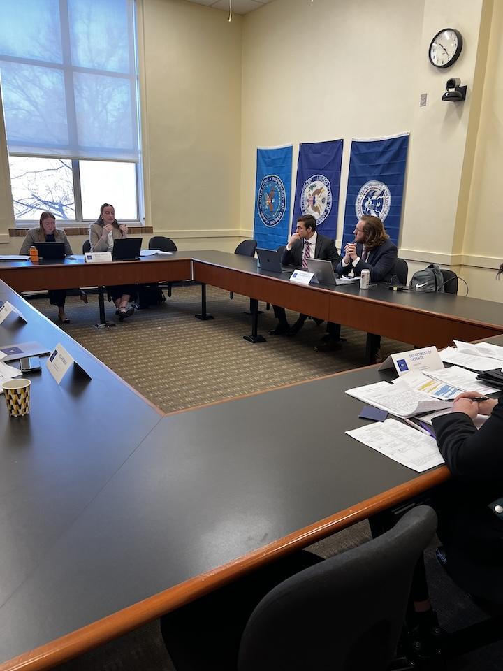 Students and professors sit around a table during the 2025 Schenck National Security Competition