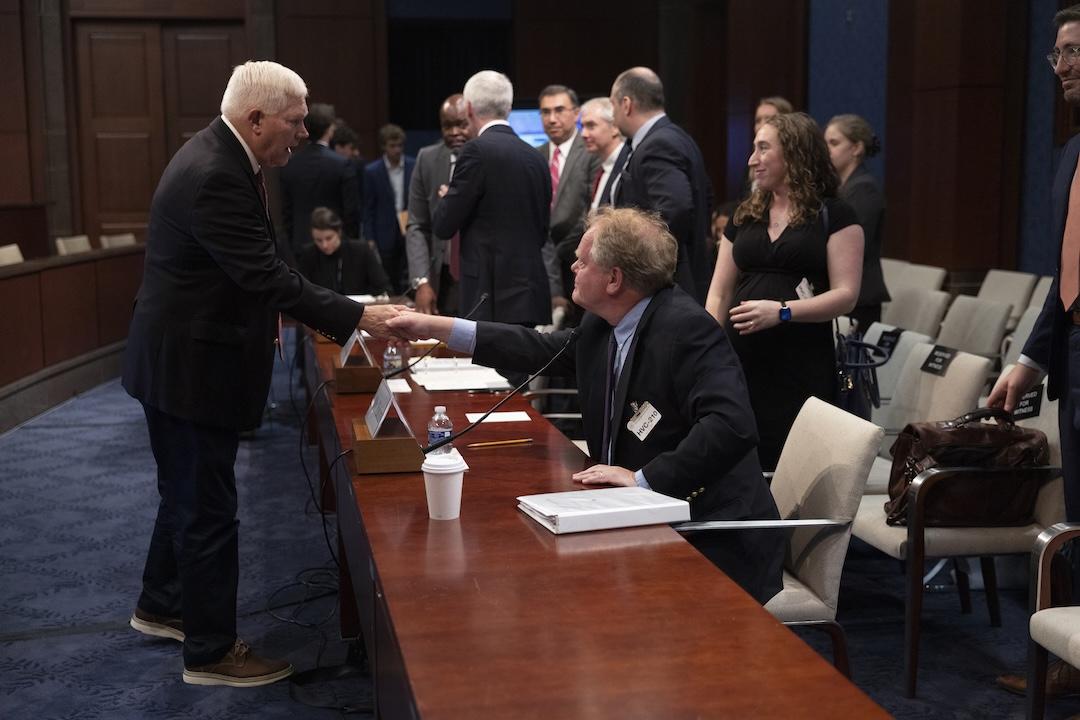 GW Law Professor Christopher Yukins shakes a lawmaker's hand following his testimony in the US House of Representatives subcommittee on July 22, 2025.