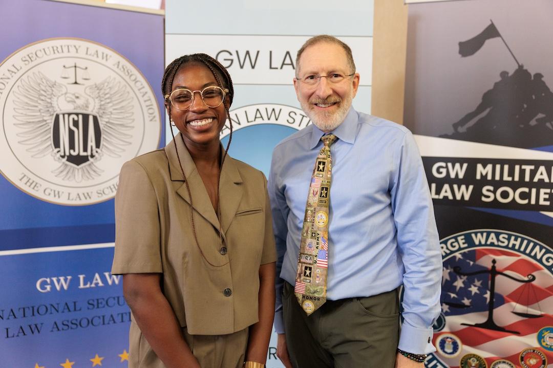 Dean Steve Schooner poses for a photo with a student during the veterans welcome back reception
