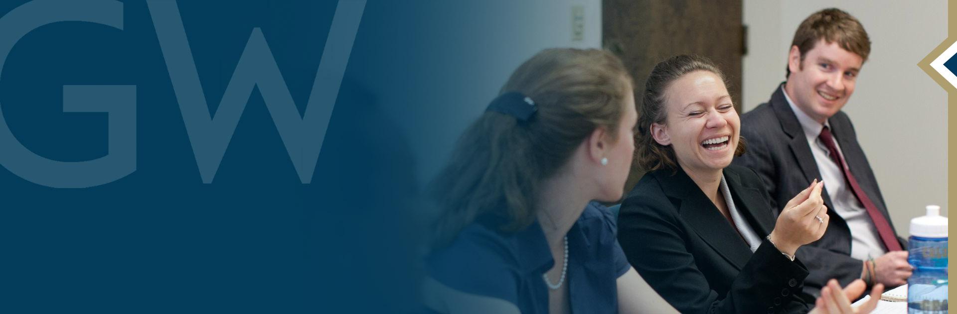 Students talking and laughing at a conference table