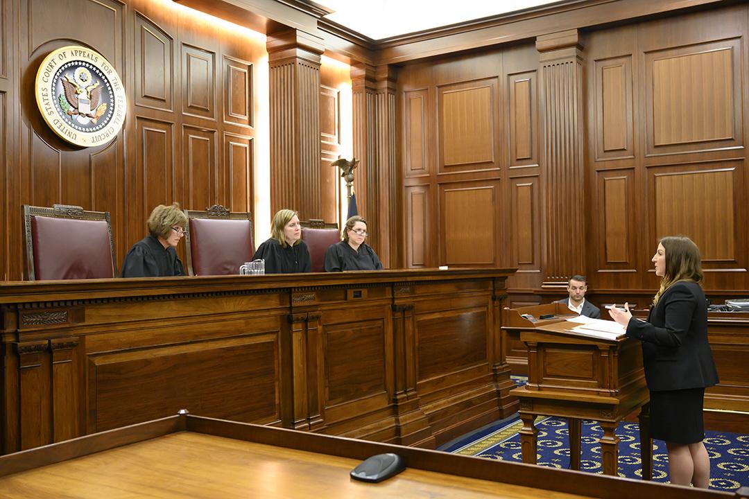 Student arguing a Government Contracts Case in front of a panel of judges
