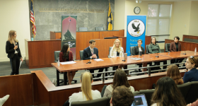 The alumni panel talking to the crowd in the moot courtroom